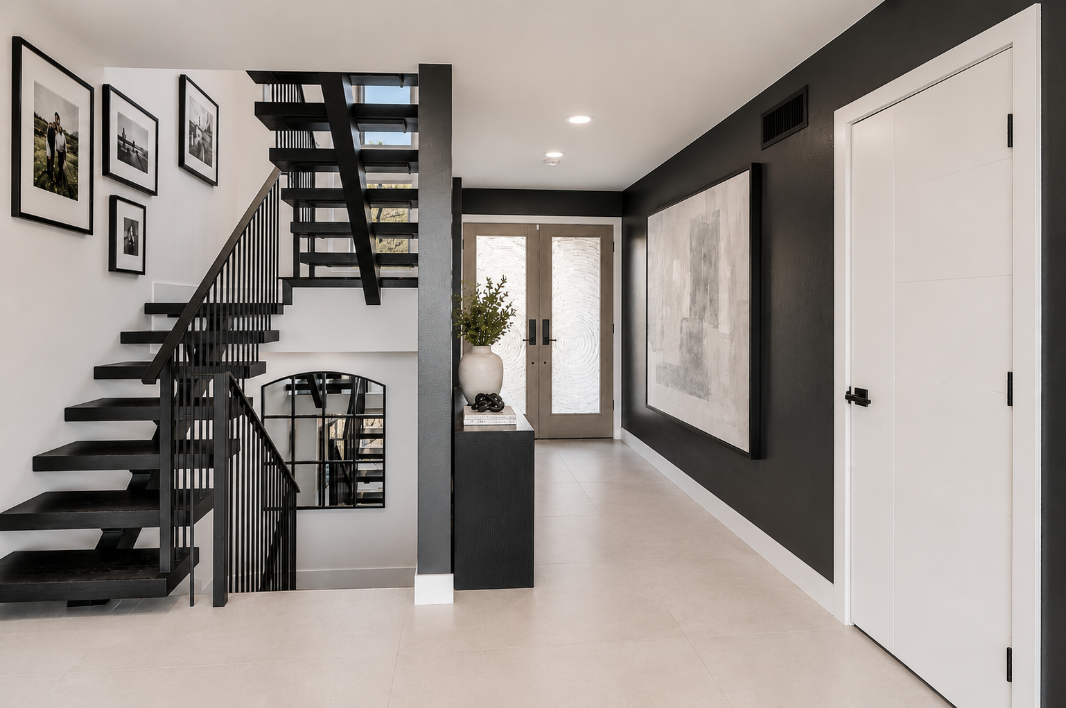 Dramatic black floating staircase with gallery wall and large abstract artwork