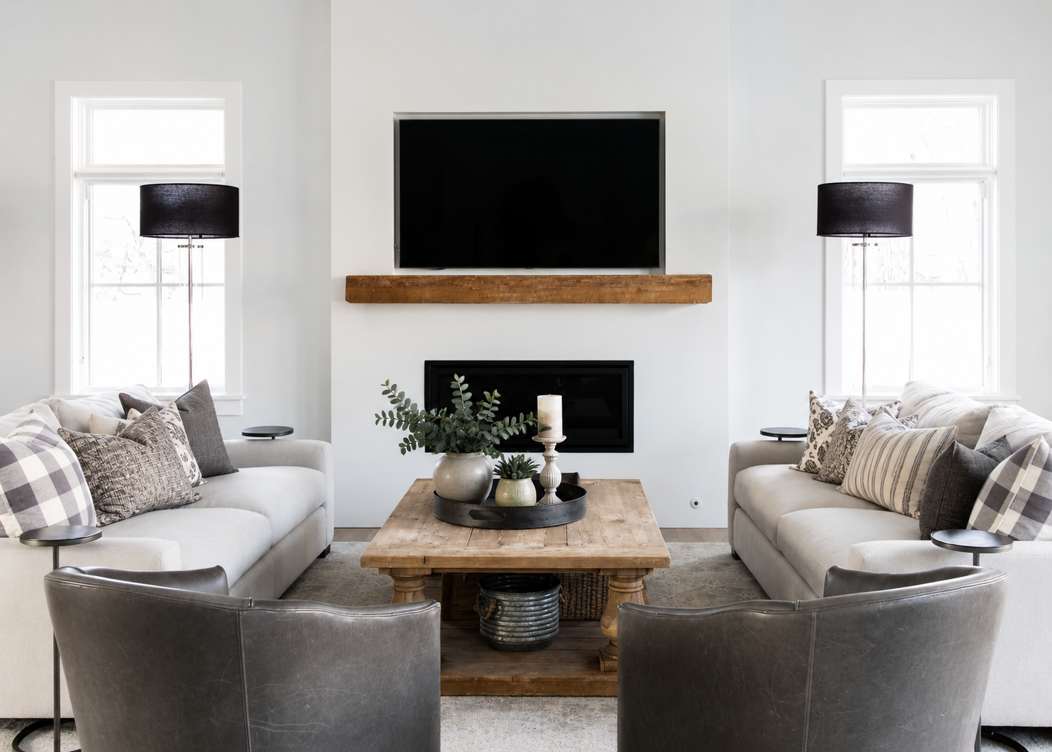 Living room with symmetrical sofas, reclaimed wood coffee table, linear fireplace, and reclaimed beam mantel